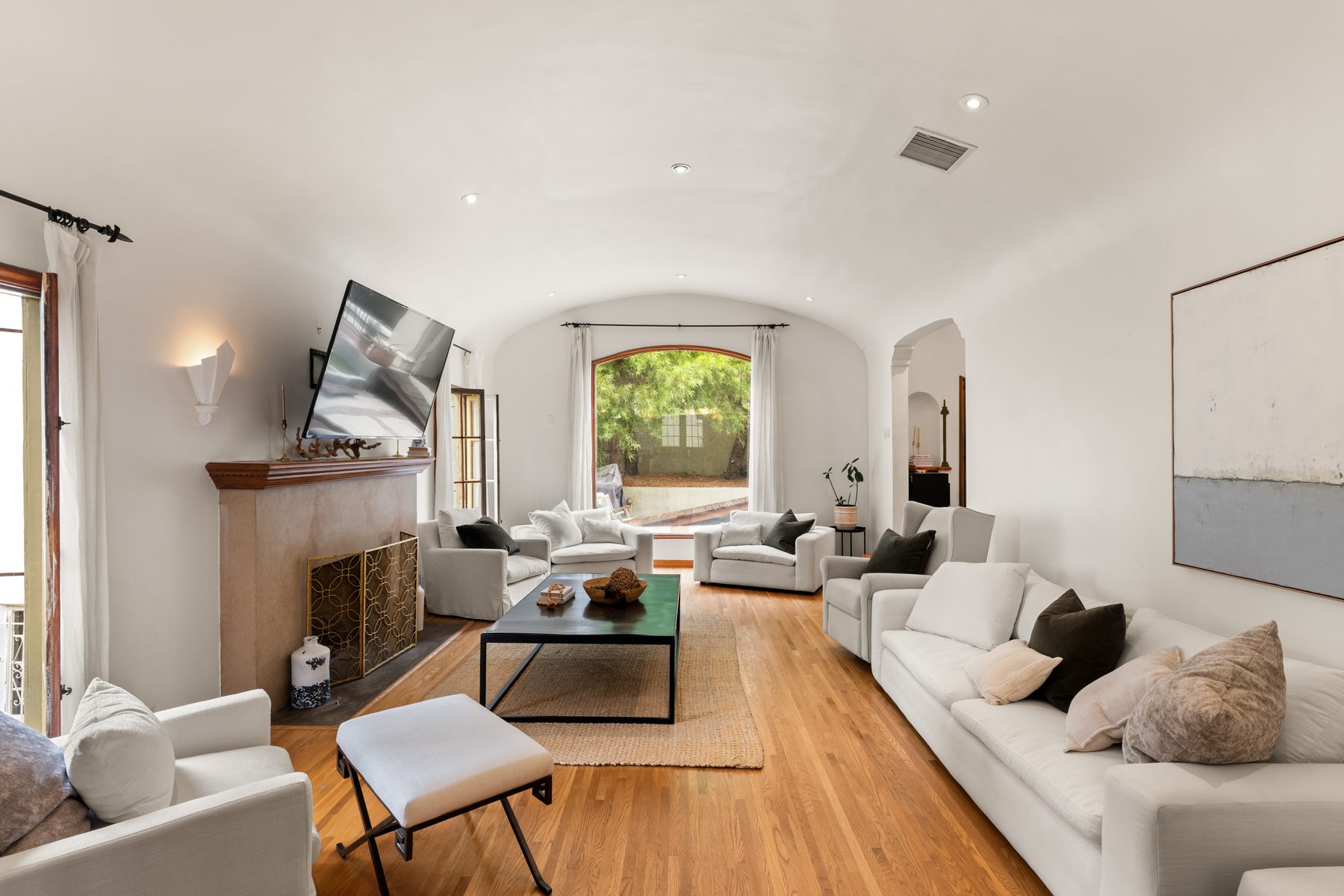 Living room with arched ceiling and French doors